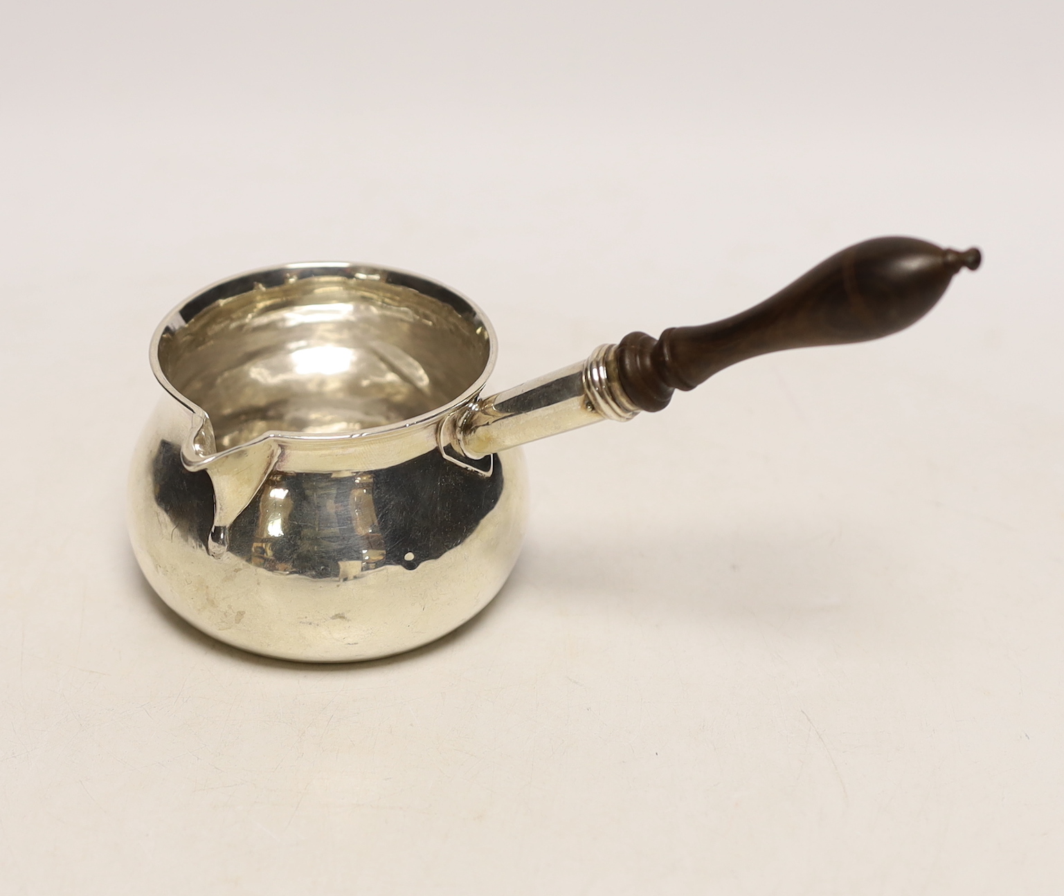 A George III silver brandy warmer, with turned wooden handle, Charles Chesterman II, London, 1786, length 17cm, gross weight 4.3oz.